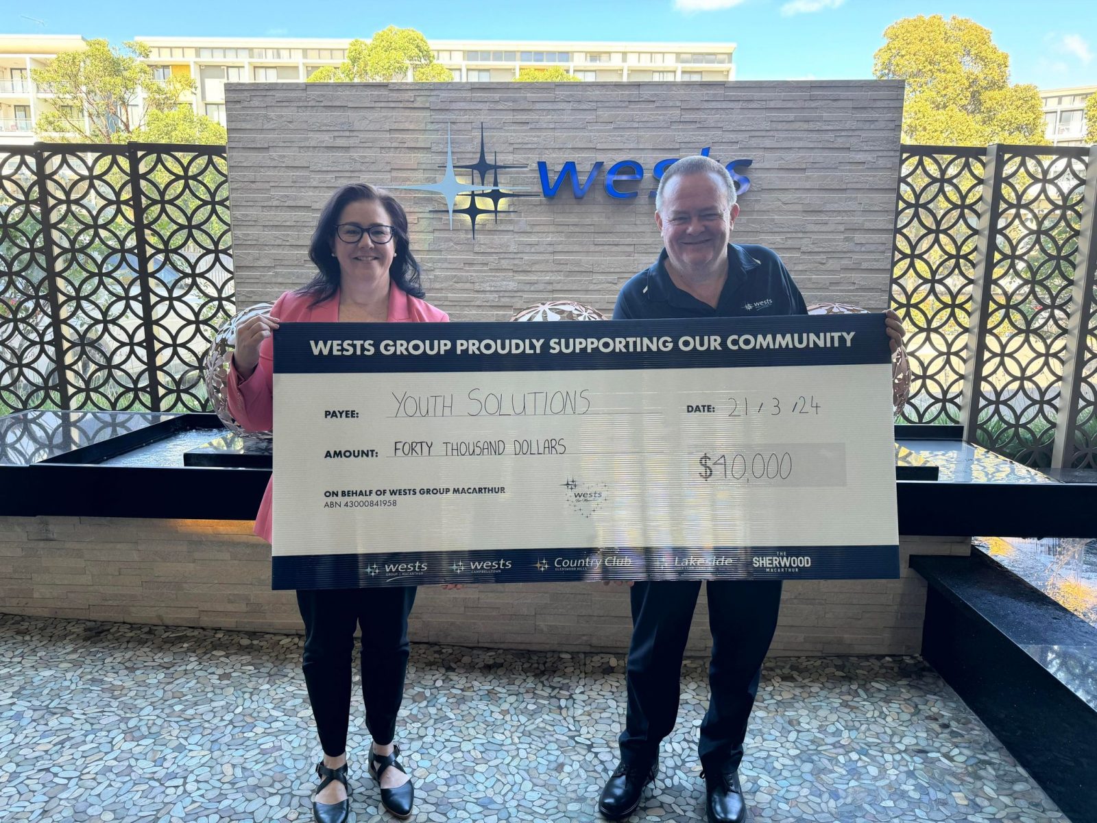 Youth Solutions CEO Geraldine Dean receives a cheque for $40,000 from Wests Group Macarthur Director Stephen Stewart for the Sports AWARE Project.